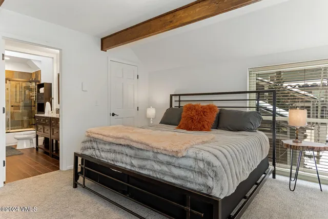 a bedroom with a bed and table