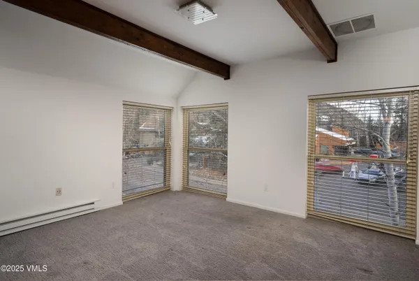 a view of an empty room with a window