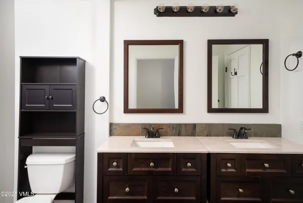 a bathroom with a double vanity sink and mirror