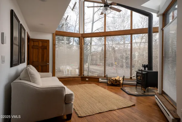 a living room with furniture and floor to ceiling window