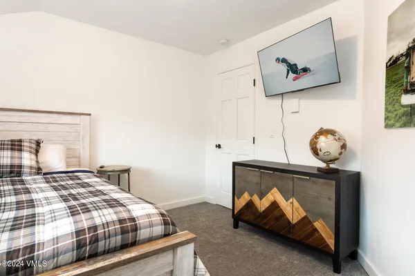 a bedroom with a bed and a wall painting