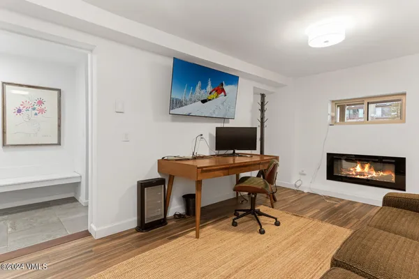 a workspace with furniture and a fireplace