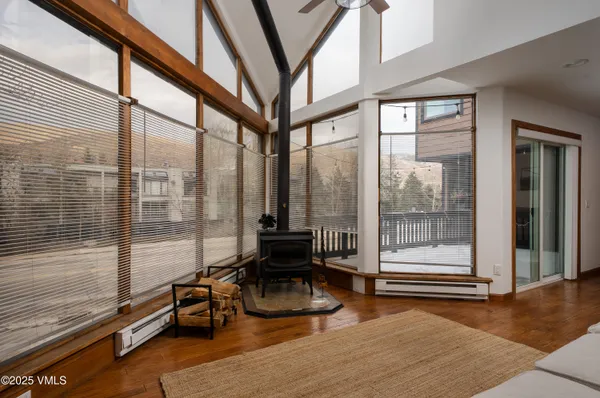 a living room with furniture and floor to ceiling windows
