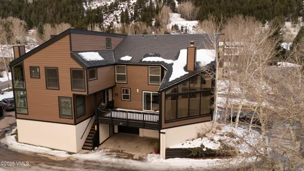 a view of a house with a wooden fence