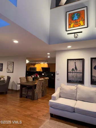 a living room with furniture and kitchen view
