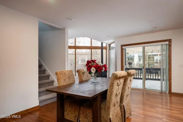 a view of a dining room with furniture window and wooden floor