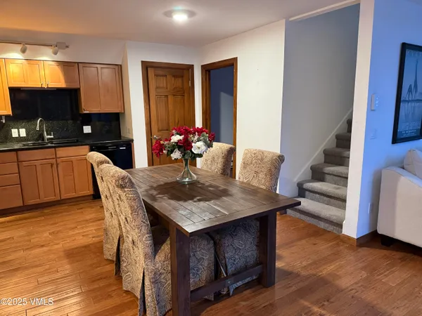 a view of a dining room with furniture and wooden floor