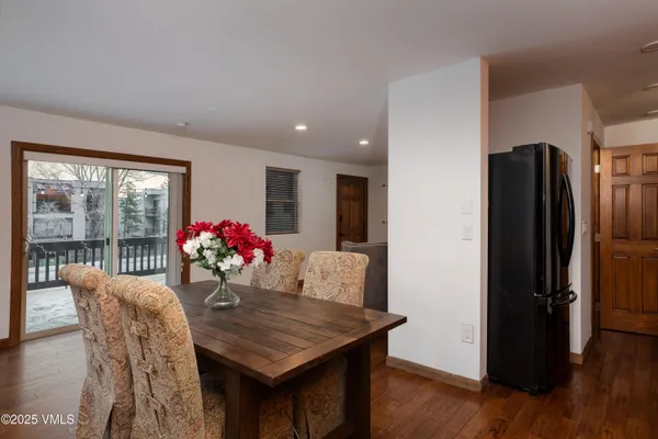a view of a dining room with furniture and a potted plant