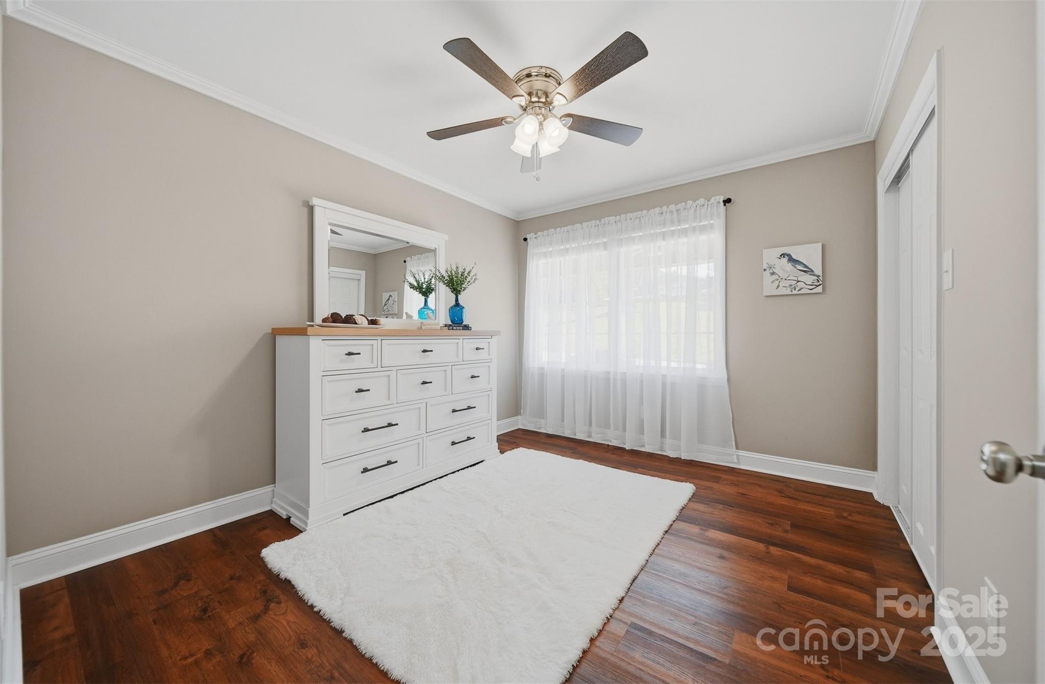 315 Skyline Road Hickory, NC 28601 - Photo 25 of 48 a view of a bedroom with cabinet a chandelier fan and wooden floor