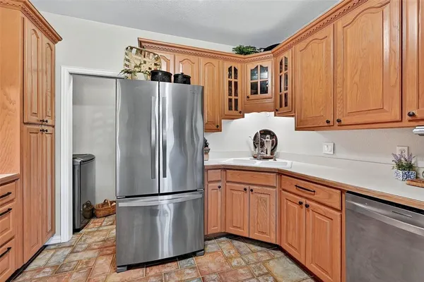 a kitchen with stainless steel appliances granite countertop a refrigerator and a sink