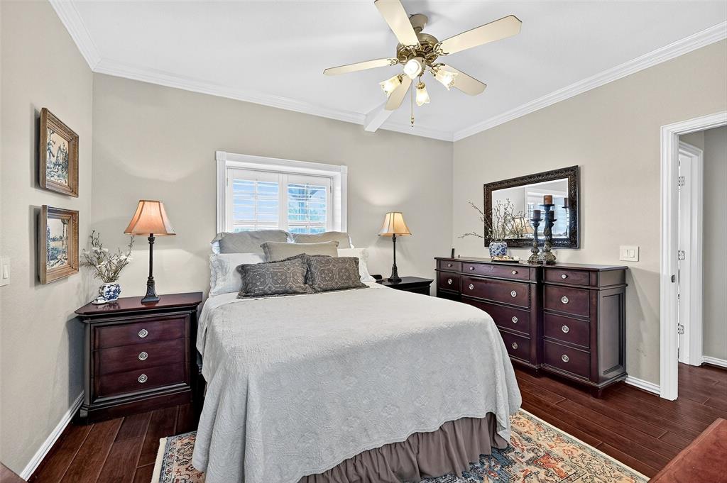 12041 Bell Road Pilot Point, TX 76258 - Photo 20 of 38 a bedroom with a bed and a chandelier