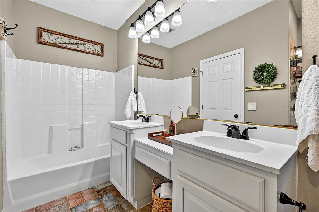 12041 Bell Road Pilot Point, TX 76258 - Photo 22 of 38 a bathroom with a sink and a mirror