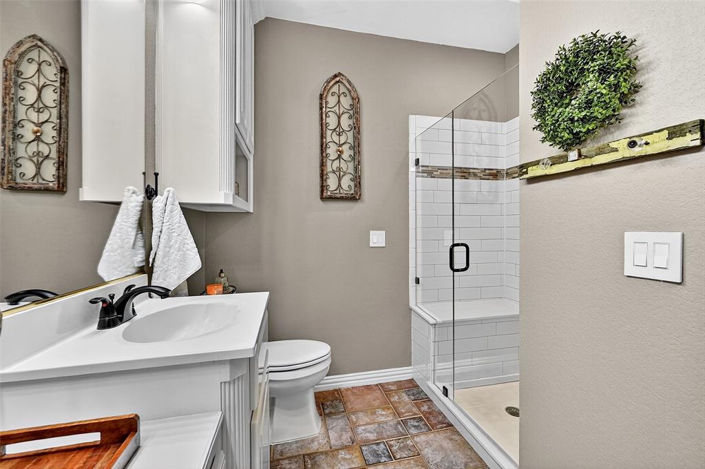 12041 Bell Road Pilot Point, TX 76258 - Photo 23 of 38 a bathroom with a sink a toilet and shower
