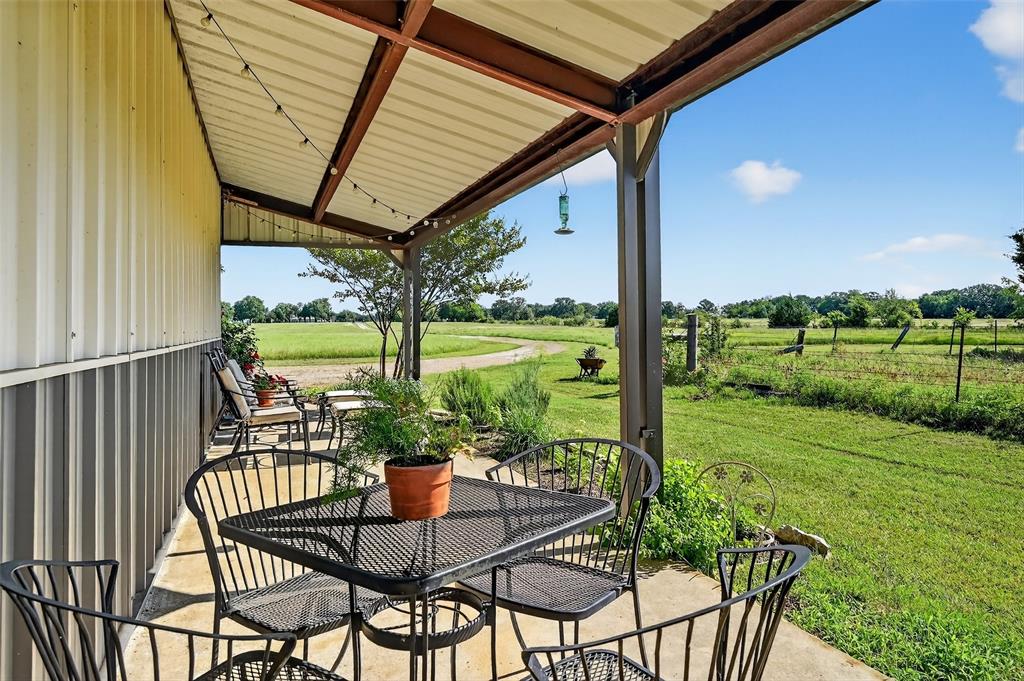 12041 Bell Road Pilot Point, TX 76258 - Photo 27 of 38 a patio with yard glass top table and chairs