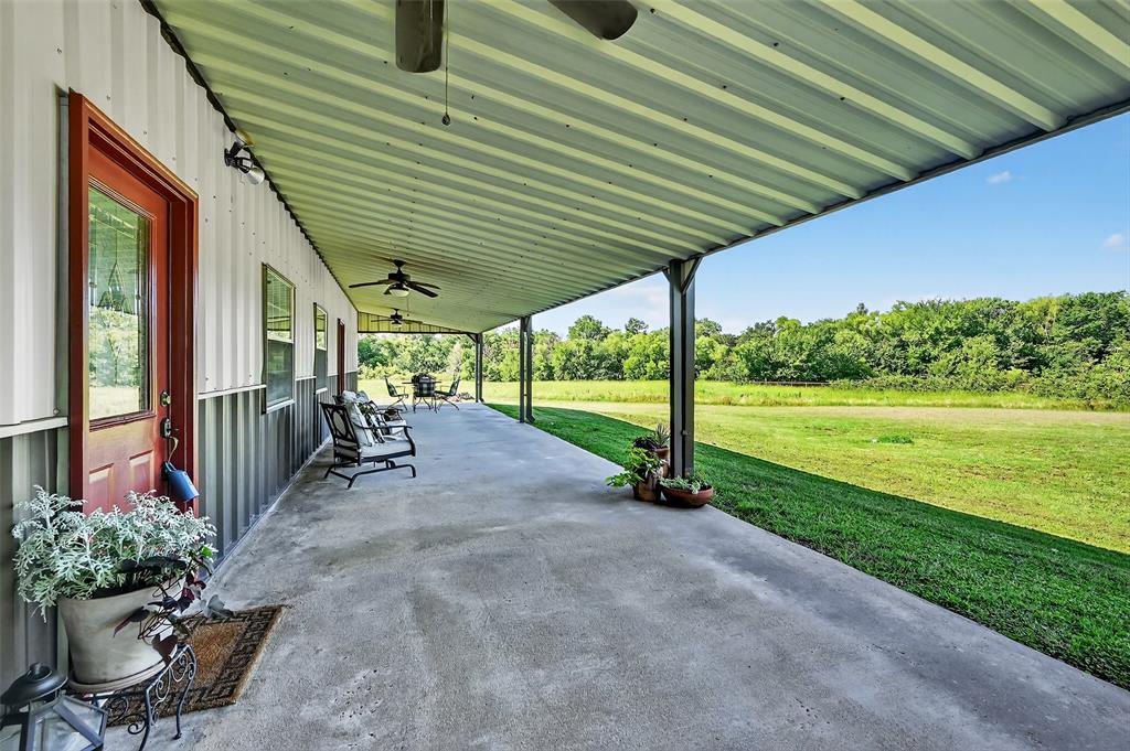 12041 Bell Road Pilot Point, TX 76258 - Photo 28 of 38 a view of a patio with table and chairs potted plants with wooden floor