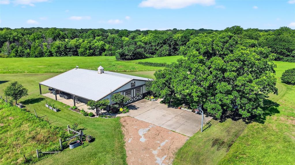 12041 Bell Road Pilot Point, TX 76258 - Photo 31 of 38 an aerial view of a house with green yard and outdoor seating