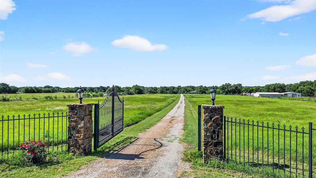 12041 Bell Road Pilot Point, TX 76258 - Photo 34 of 38 a view of a lake with a garden