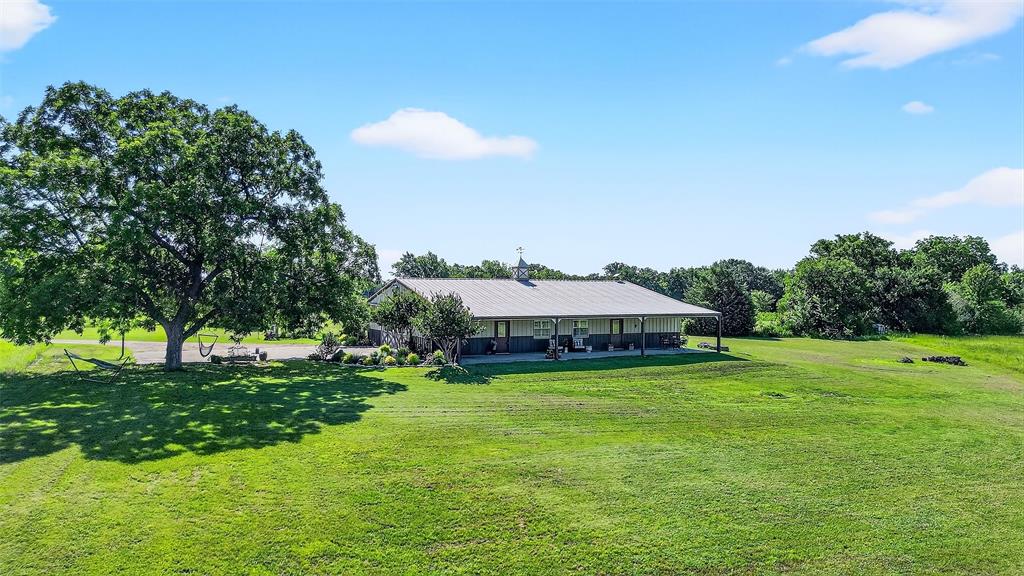 12041 Bell Road Pilot Point, TX 76258 - Photo 36 of 38 a view of a patio with a yard