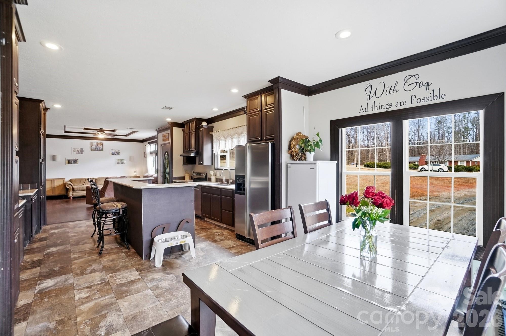 158 Cooks Lake Road Gastonia, NC 28056 - Photo 12 of 27 a view of a dining room with furniture a kitchen and chandelier