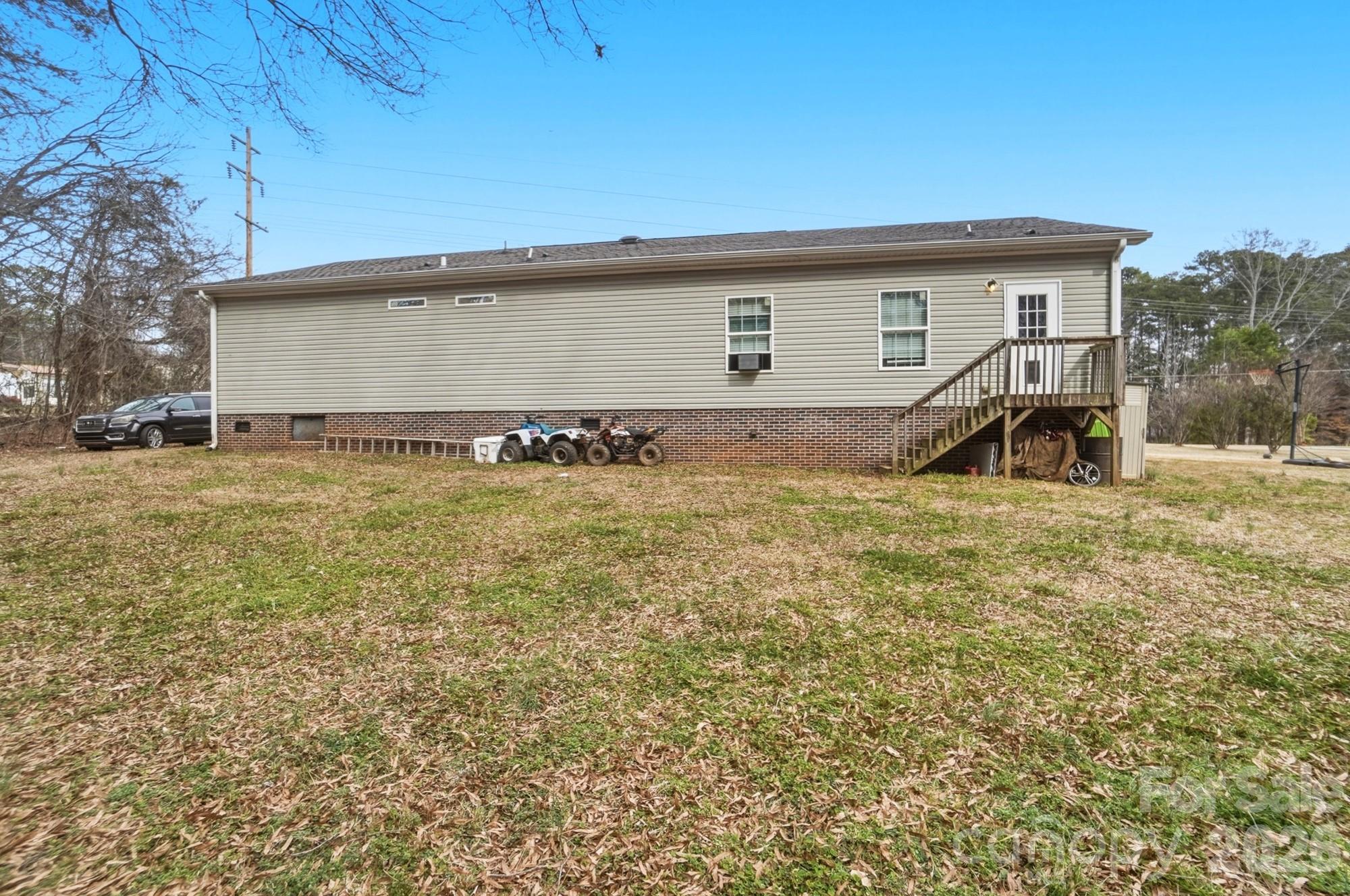 158 Cooks Lake Road Gastonia, NC 28056 - Photo 25 of 27 a backyard of a house with table and chairs