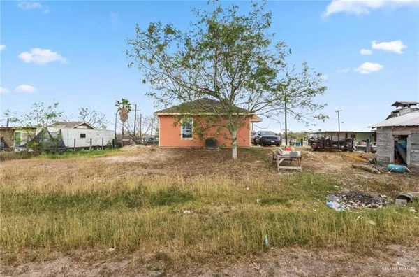 a backyard of a house with table and chairs