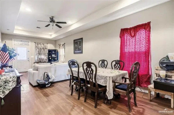 a view of a a dining room with furniture window and wooden floor