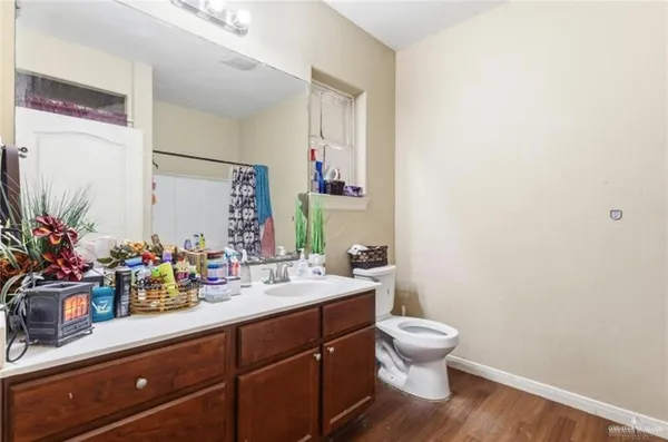 a bathroom with a toilet sink and mirror
