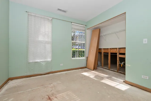 a bathroom with a granite countertop toilet and a sink