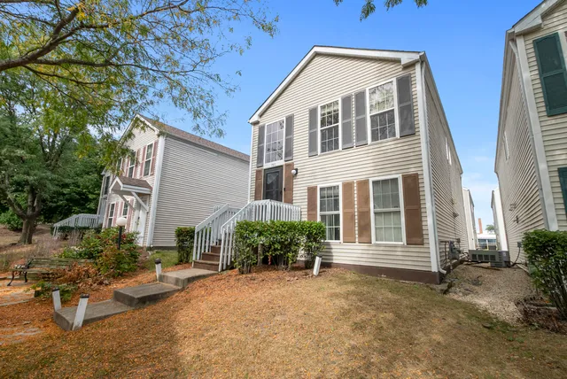a view of a house with backyard and sitting area