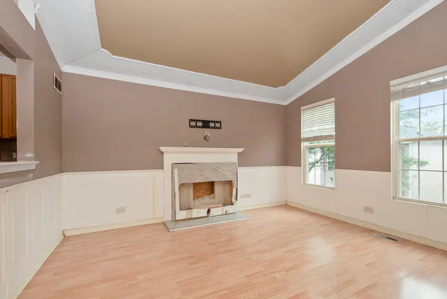 a view of empty room with a fireplace and window