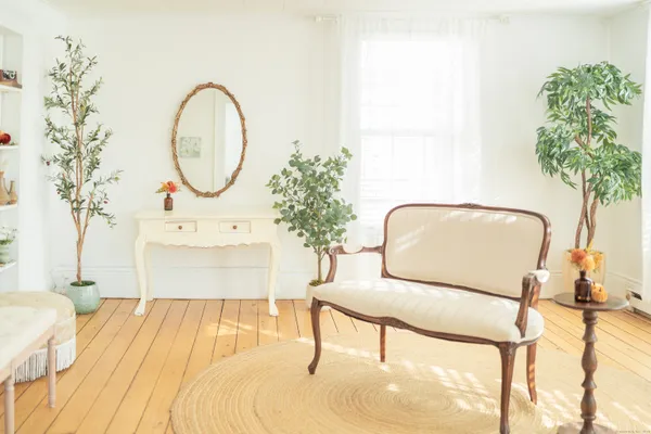a living room with furniture and wooden floor