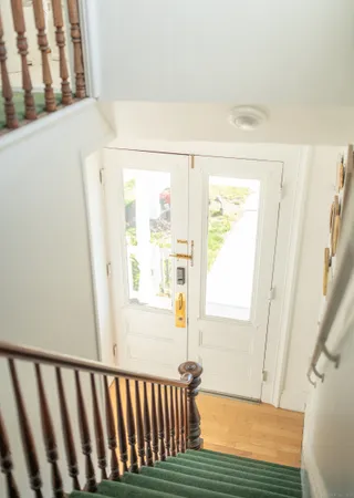 a view of an entryway with wooden floor