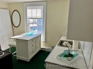 a kitchen with a refrigerator and a stove top oven