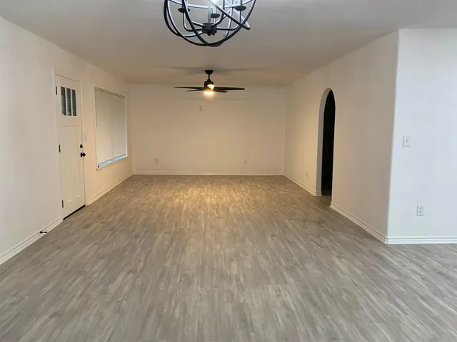 wooden floor in a hall with a window