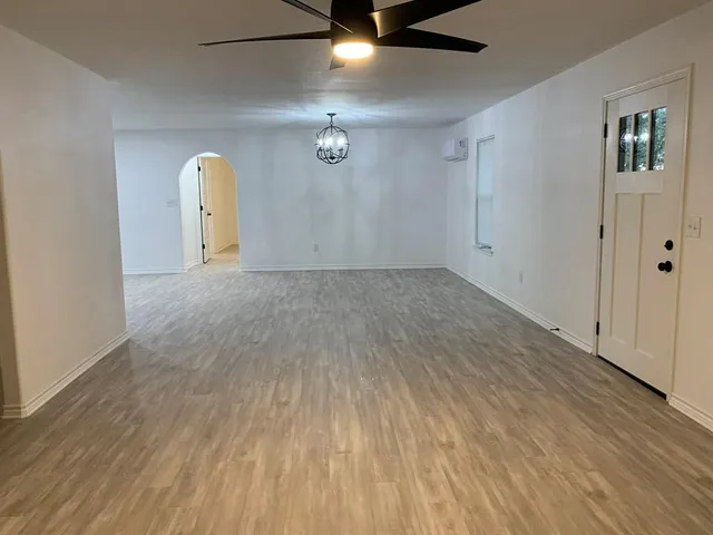 a view of a hallway with wooden floor