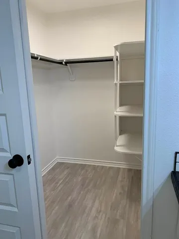 a bathroom with a double vanity sink a toilet a mirror and shower