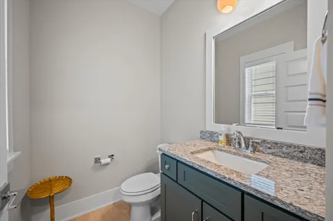 a bathroom with a granite countertop toilet a sink and bathtub