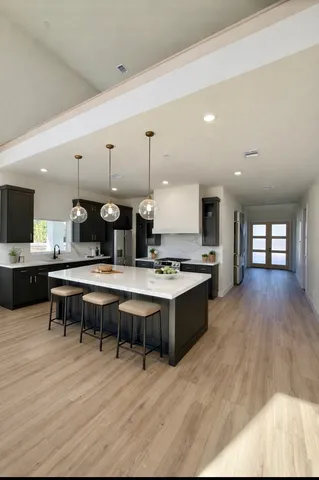a large kitchen with a table and chairs