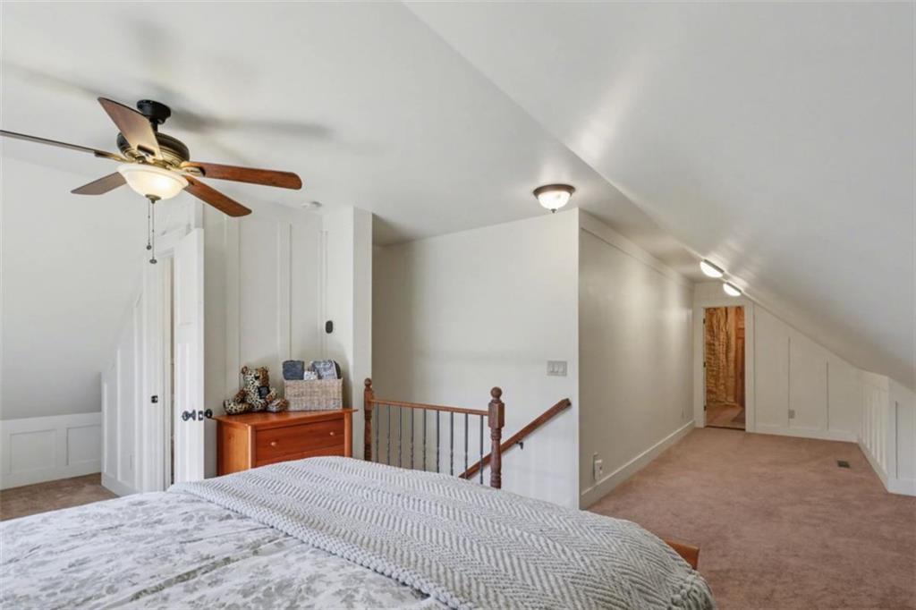 899 Ridge Pointe Way Blairsville, GA 30512 - Photo 66 of 88 a bedroom with a bed and a chandelier