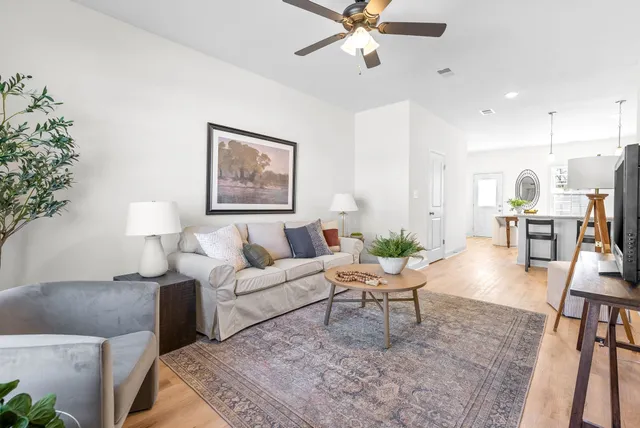 a living room with furniture and a chandelier