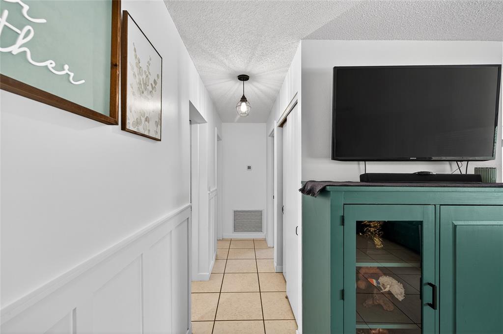 532 Center Road Venice, FL 34285 - Photo 20 of 68 a living room with a flat screen tv and a fireplace