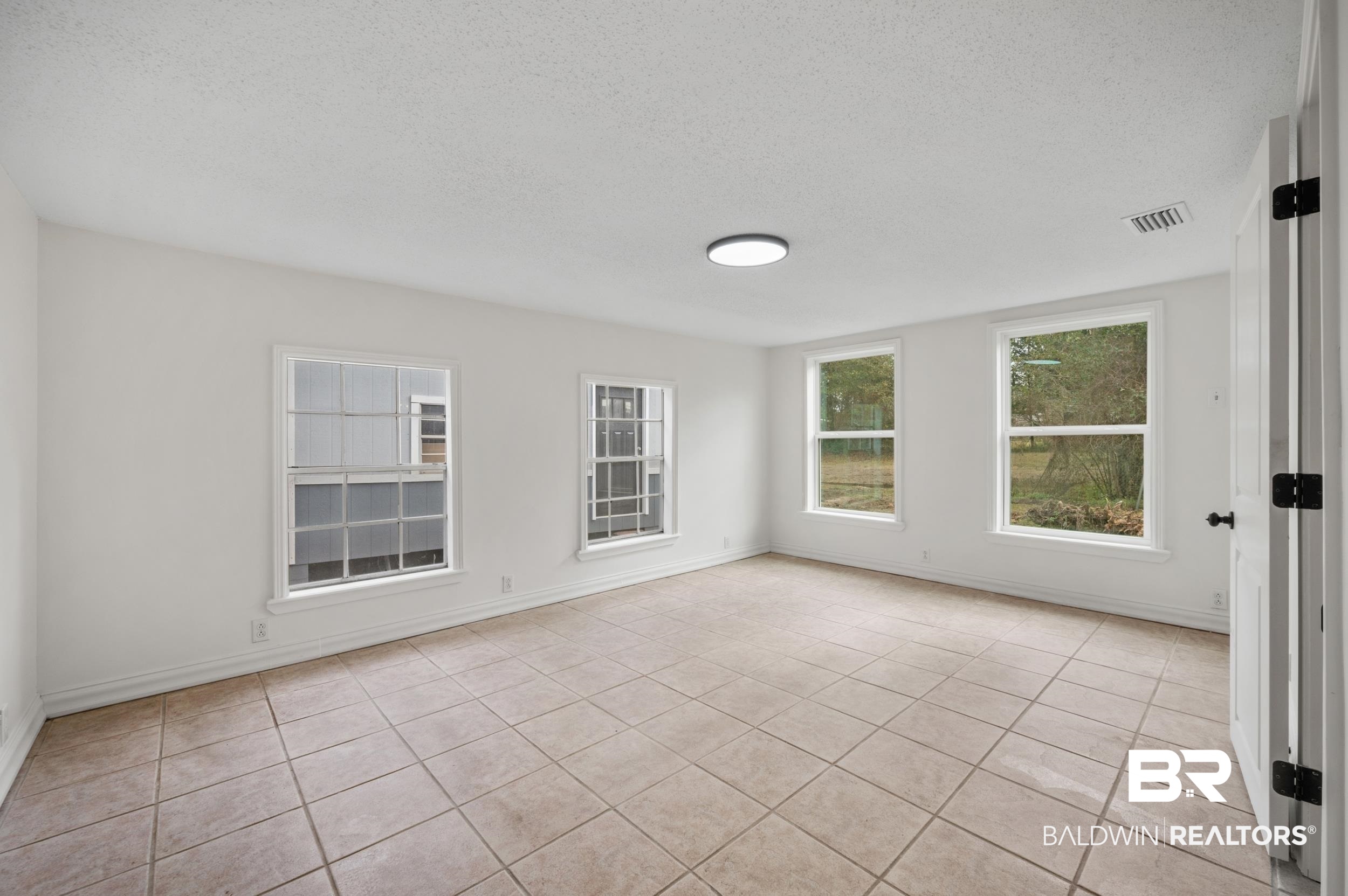 35780 Spring Road North Stapleton, AL 36578 - Photo 18 of 41 Empty room featuring a textured ceiling and light tile patterned floors