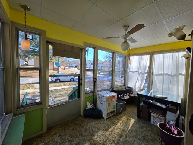a room with pool table and windows