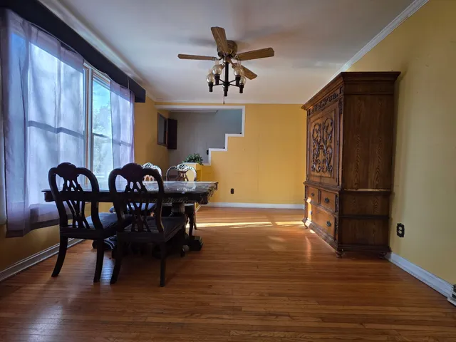 a dining room with furniture and window