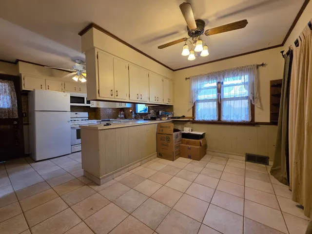 a kitchen with stainless steel appliances granite countertop a sink counter space and cabinets