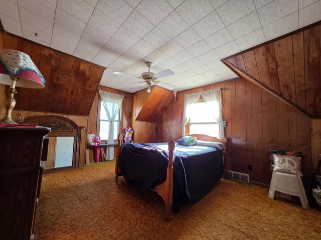 a bed room with a bed and a chair