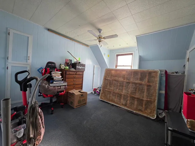 a bedroom with furniture and a gym equipment