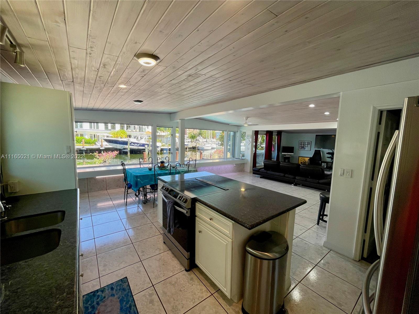 3 Sunset Lane Lauderdale-by-the-Sea, FL 33062 - Photo 11 of 36 a kitchen with stainless steel appliances granite countertop a sink a stove and a refrigerator