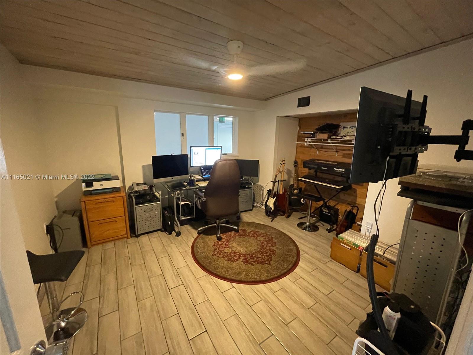 3 Sunset Lane Lauderdale-by-the-Sea, FL 33062 - Photo 17 of 36 a view of a workspace with furniture and wooden floor