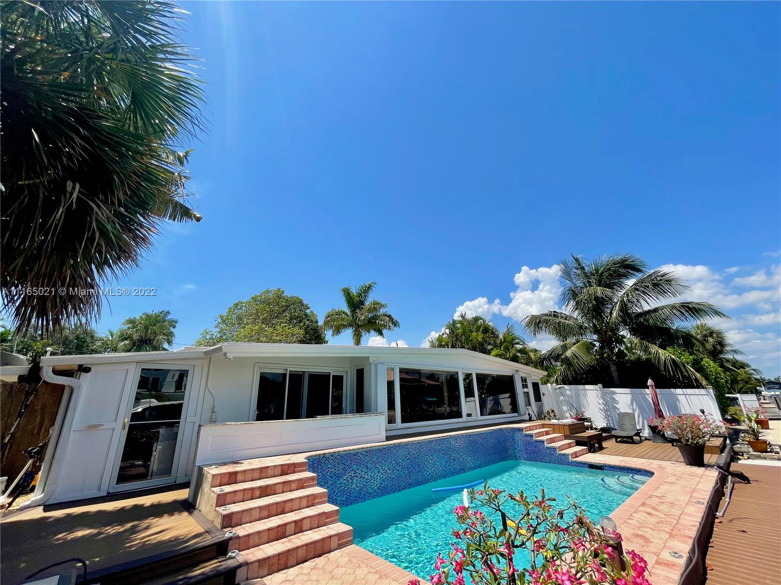 3 Sunset Lane Lauderdale-by-the-Sea, FL 33062 - Photo 2 of 36 a front view of house with yard outdoor seating and barbeque oven